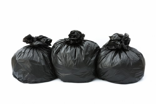 Loading waste into a skip container