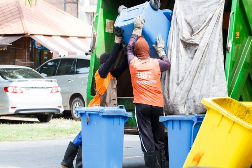 Man and van loading waste from a flat near Morden station